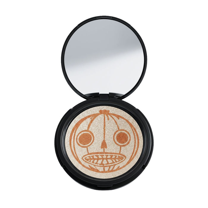 A round highlighter compact with a black case, shown open with a mirror in the lid and a pressed powder pan featuring a orange design of Enoch