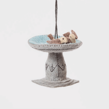 Celebrate the gentle rhythms of the garden with our Bird Bath Ornament. This charming felt scene features two tiny birds enjoying a quiet splash, capturing the simple joy of watching backyard birds gather for a drink on a sunny day.