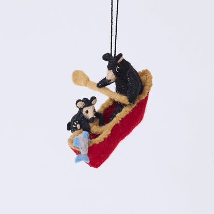 Handmade felt Bears in a Canoe ornament from Craftspring rotating to show front, side, and back views—featuring a mama bear paddling a canoe with a cub climbing over the side, ethically crafted by artisans using sustainable wool.