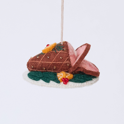 Handmade felt Spiral Ham Platter ornament from Craftspring rotating to show front, side, and back views—featuring intricate beaded and embroidered details on a festive ham, ethically crafted by artisans using sustainable wool.