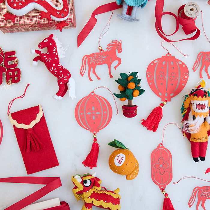 Craftspring’s Paper Lantern Ornaments arranged with other felt and paper Lunar New Year pieces, creating a rich festive scene. Ethically handmade by artisans for heirloom-worthy holiday decor.