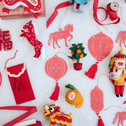 Craftspring’s Paper Lantern Ornaments arranged with other felt and paper Lunar New Year pieces, creating a rich festive scene. Ethically handmade by artisans for heirloom-worthy holiday decor.