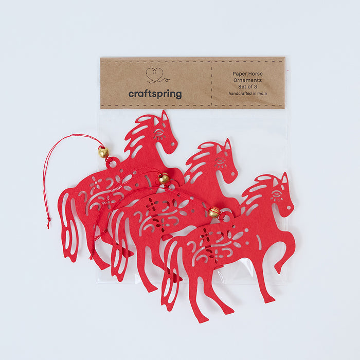 Craftspring packaging for Paper Horse Ornaments - Set of 3, displayed on top of clear bag packaging—ready to safely deliver heirloom-quality, ethically handmade Lunar New Year decor, crafted by skilled artisans.