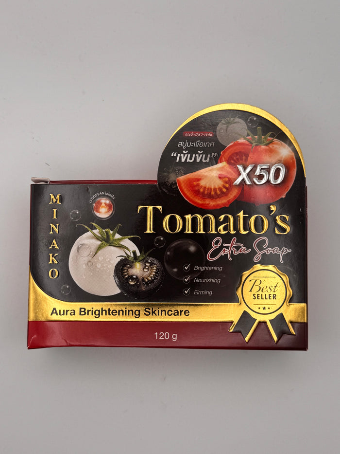 Black, red and gold box of Minako Tomato's Extra Soap with an X50 concentrated tomato badge, Best Seller rosette, and Aura Brightening Skincare, 120 g