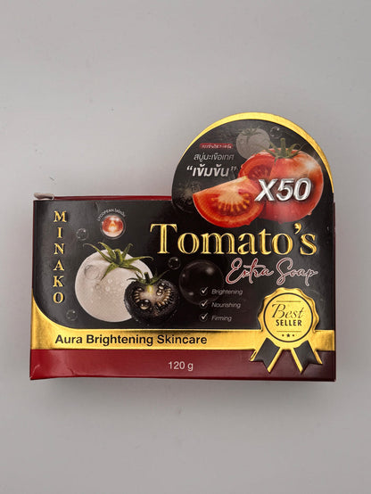 Black, red and gold box of Minako Tomato's Extra Soap with an X50 concentrated tomato badge, Best Seller rosette, and Aura Brightening Skincare, 120 g