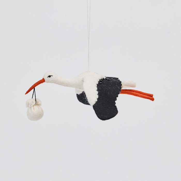 Handmade felt New Baby Stork ornament from Craftspring, featuring a stork carrying a bundle with intricate beaded and embroidered details—showcasing artisan craftsmanship and heirloom-quality design, ethically crafted using sustainable wool.