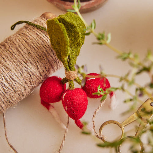Hand-felted radish bunch ornament with green leaves and red bulbs for garden-inspired decor