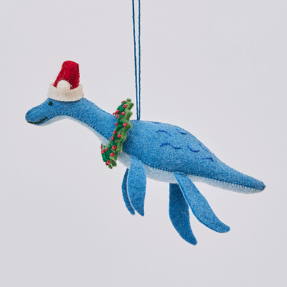Handmade felt Santa Plesiosaurus ornament from Craftspring rotating to show front, side, and back views—featuring a dinosaur with a Santa hat, festive wreath, and intricate beaded and embroidered details, showcasing heirloom quality and artisan craftsmanship, ethically crafted using sustainable wool.