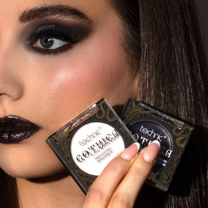 Woman with dramatic makeup holding a 'technic' makeup palette