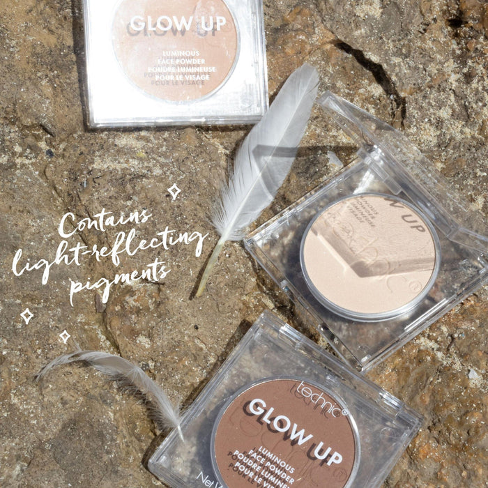 3 of the powders on a rock with 2 white feathers around them. Text saying "Contains Light-Reflecting Pigments"