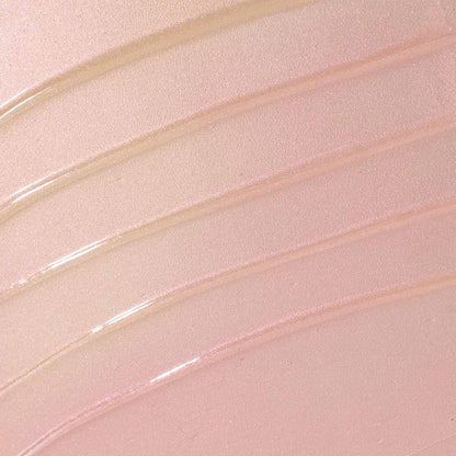 A close-up texture swatch of the Over the Garden Wall body oil: shimmering, light pink to gold tone